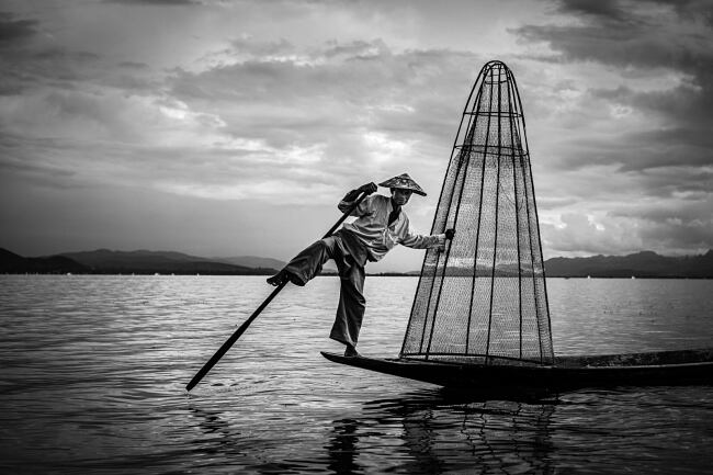 Fishermen on Inle Lake, Myanmar, often use a distinctive style of paddling using their feet - Leo Smith Photo Video
