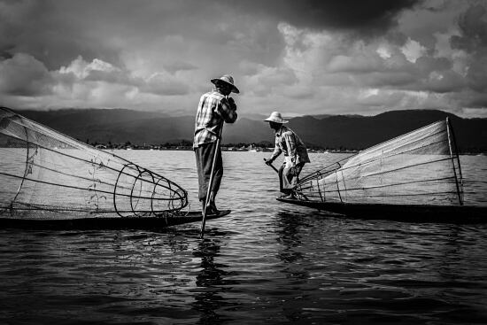 Fishermen on Inle Lake, Myanmar, often use a distinctive style of paddling using their feet - Leo Smith Photo Video