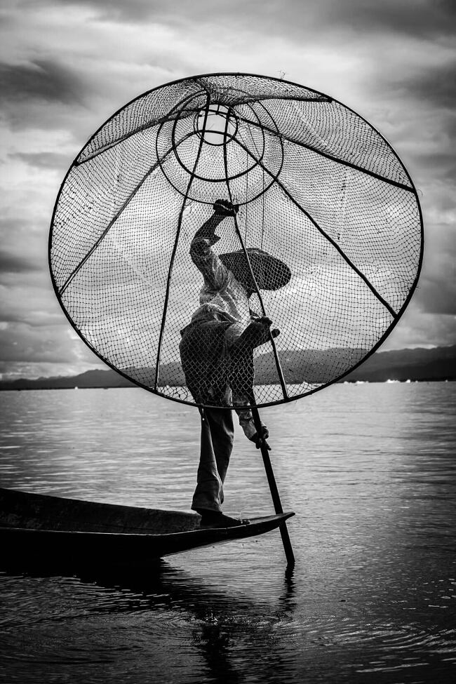 Fishermen on Inle Lake, Myanmar, often use a distinctive style of paddling using their feet - Leo Smith Photo Video