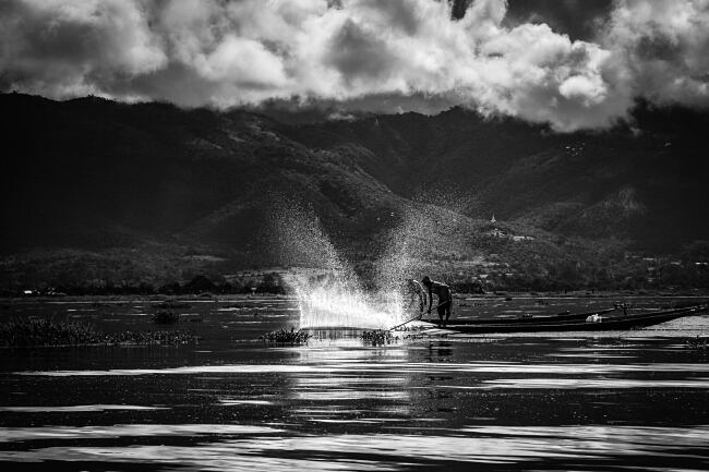 Fishermen on Inle Lake, Myanmar, splash the water with large poles - Leo Smith Photo Video