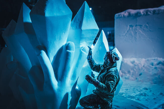 A man carves an ice sculpture during the Carnaval de Québec (Quebec Winter Carnival) - Leo Smith Photo Video